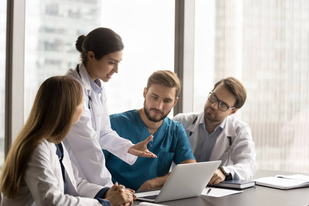 istock Group of multinational doctors gathers together to discuss patient case 2201887177