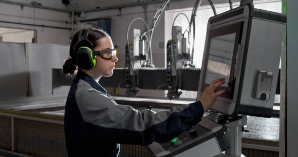 istock Young Female Technician Operating CNC Water Jet Cutting Machine in Industrial Workshop 2201887538