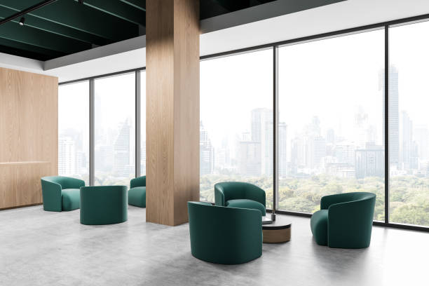 istock Modern office lounge area with green chairs and large windows overlooking a cityscape. 3D Rendering 2201888083