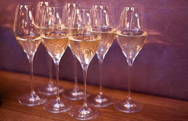 istock glasses of white wine on the table. 2201888314