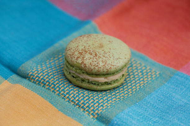 Pistachio macaron on a colorful tablecloth