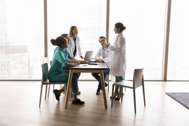 istock Young Indian female doctor performs, make speech during concilium 2201889990