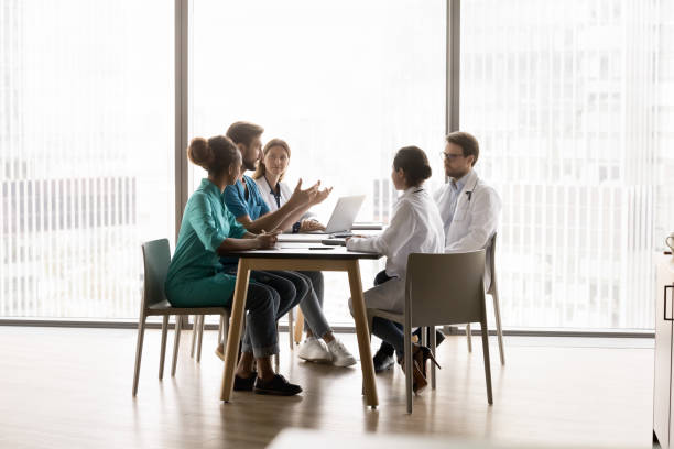 istock Five multiethnic medical workers take part in meeting 2201890719
