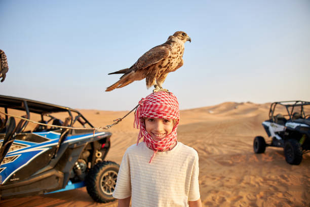 Desert safari outside Dubai, UAE. Adventure, extreme sports, tourist activities in the desert. Sport car driving on sand dunes. Orange golden sand in the desert.