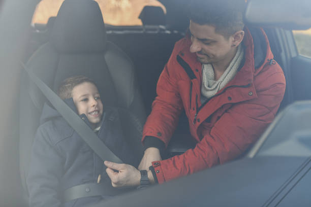 istock Father Making Sure He's Son is Safe During Drive Fastening His Seat Belt 2201891371