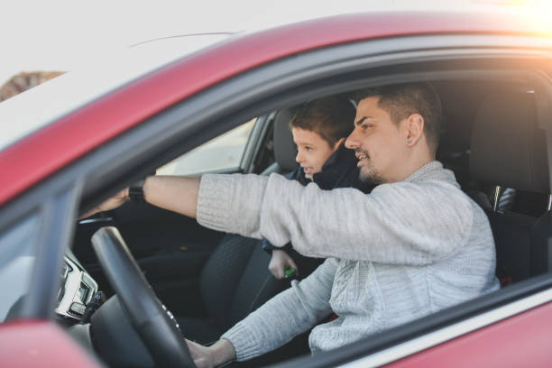 istock Son Looking in Distance With Curiosity While Father is Pointing at Animals Crossing Road in Front of Them 2201891492