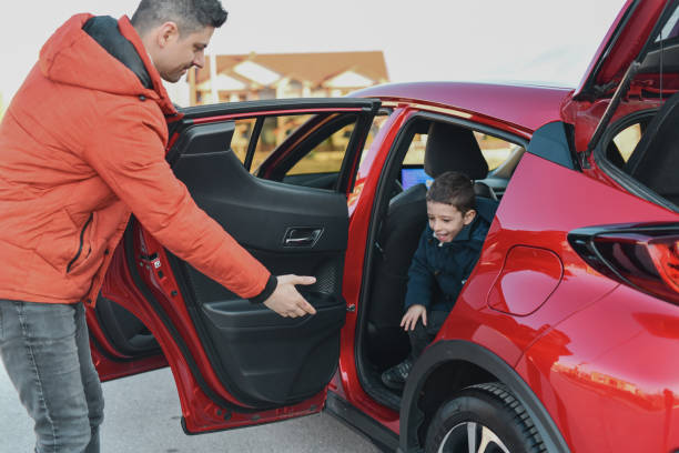 istock Caring Father Opening Son's Car Door Helping Him Getting Out 2201891737