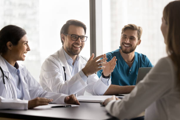 istock Laughing doctors lead talk, enjoy pleasant friendly collaboration during briefing 2201892350