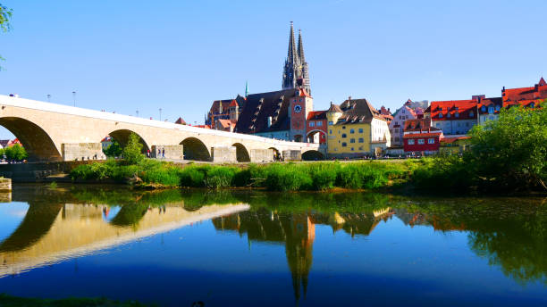 istock Regensburg, Germany: The water reflects the bridge and cathedral 2201893429