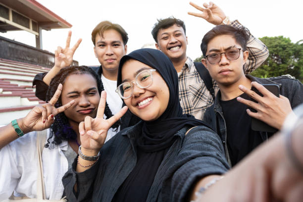 istock Happy multi-ethnic Asian students taking a selfie with mobile phone app at university campus 2201893703