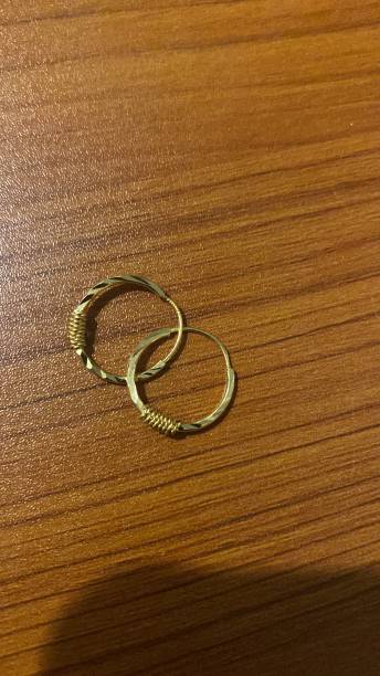 istock The golden earrings view on the table 2201894624