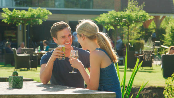 istock Couple On Date Enjoying Outdoor Summer Drink At Pub 2201894769
