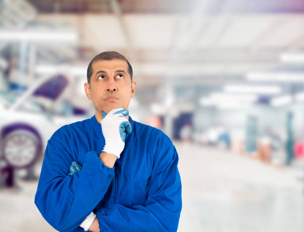 istock Mechanic man in doubt at repair shop. 2201895543