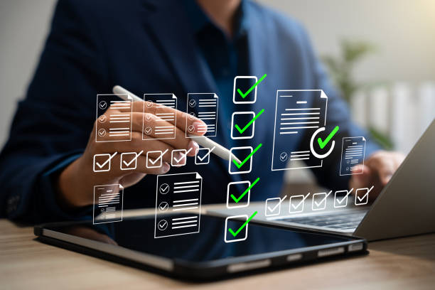 istock Checklist performance monitoring concept,Businessman using pen tick checkbox for quality control checklist,Approving business project documents in online application.Online survey,Filling digital form 2201898380