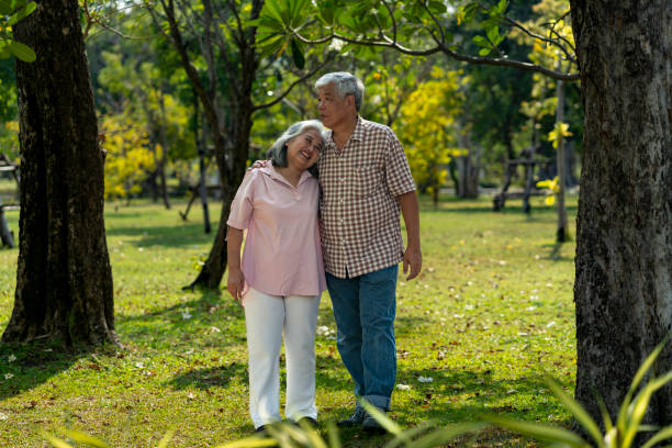 istock Romantic elderly couple holding hands looks happy in the park 2201899199