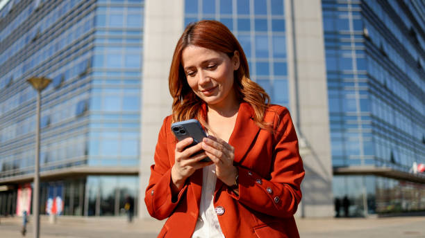 istock A gorgeous lady scrolling on her phone while enjoying the urban scenery 2201899300