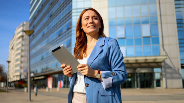 istock Beautiful woman enjoying in the city and using a digital tablet 2201899608