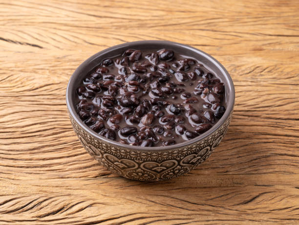 istock Cooked black beans in a bowl over wooden table 2201901755