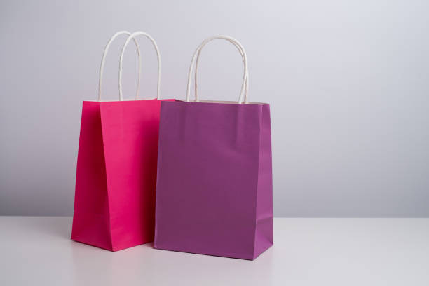 istock Color paper bag on a light background. Delivery and shopping concept. Packaging template mockup 2201905690