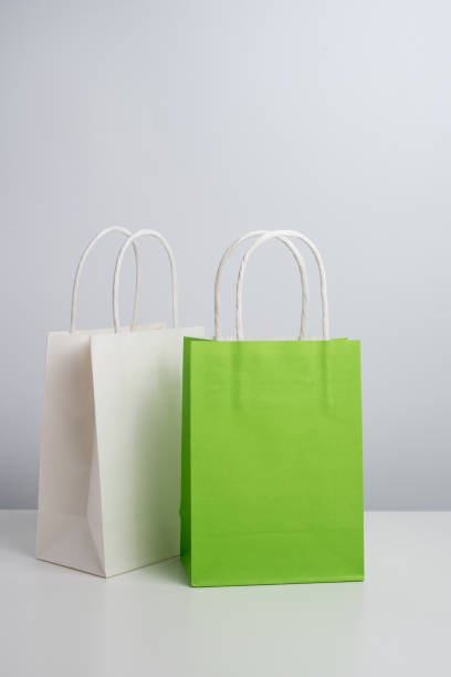 istock Color paper bag on a light background. Delivery and shopping concept. Packaging template mockup 2201905694