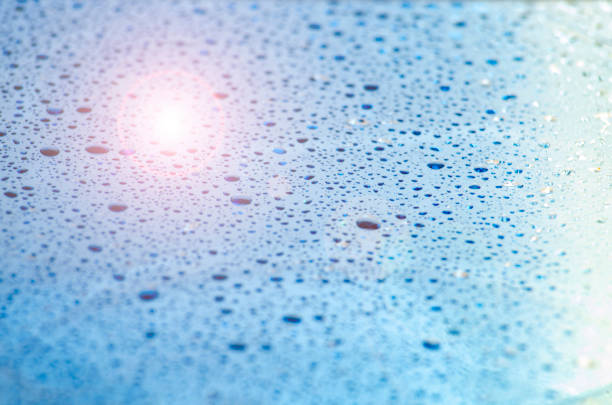 Water droplets on an ocean blue color background with customizable space for text or ideas.