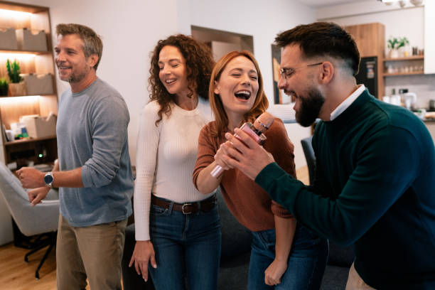 istock Friends playing karaoke at home 2201910399
