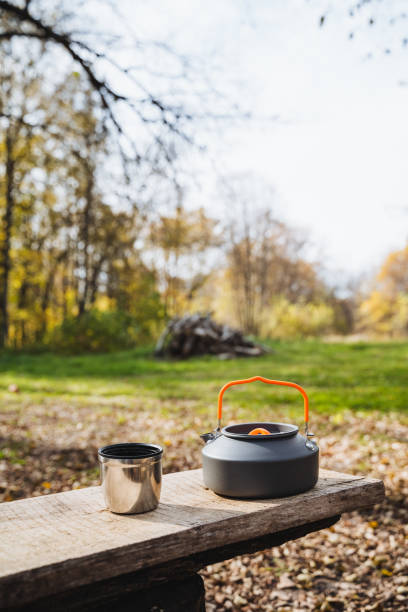 istock A charming kettle and a lovely cup sit peacefully and contentedly on a rustic wooden bench, nestled in the serene woods, surrounded by the incredible beauty and tranquility of nature itself 2201910495