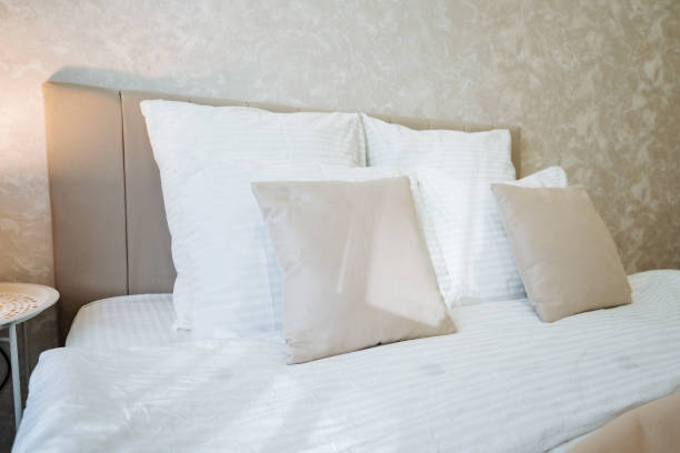 istock In a cozy, inviting bedroom, a luxurious bed with crisp white sheets and fluffy, soft pillows creates a perfectly serene atmosphere for restful, rejuvenating nights of undisturbed sleep 2201910520