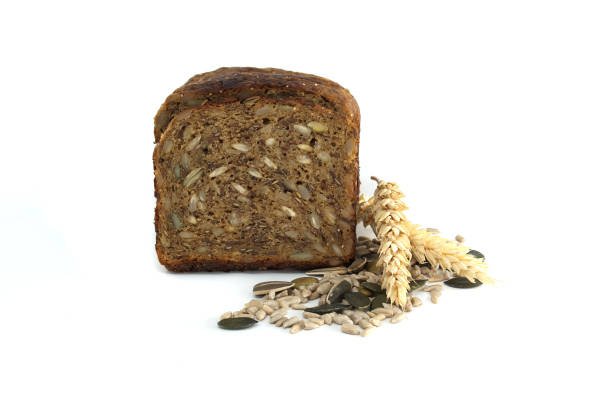 istock A nutritious slice of multigrain bread featuring an array of seeds and a single sprig of wheat. 2201911320
