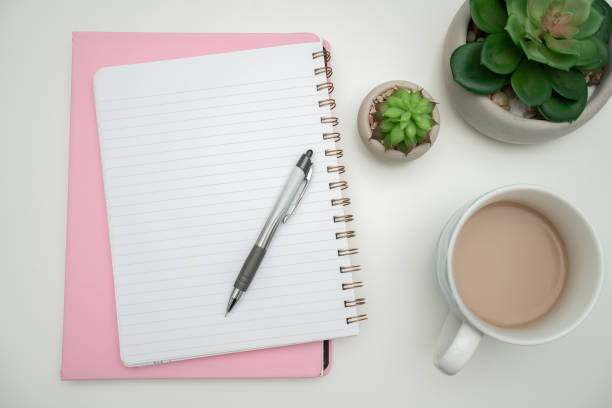 istock Office Supplies Over Desk With Keyboard And Glasses And Coffee Cup For Working Remotely, Assorted School Utilities For Studying With Hot Drink And Eyeglasses. 2201912419
