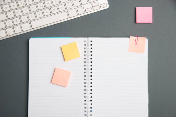 istock Keyboard Over A Table Beside A Notebook And Pens With Sticky Notes. Computer Keypad On Top Of A Desk With A Office Supplies And Desk Photo.. 2201912511