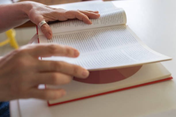 istock Close-up of a woman's hand with a book 2201917690