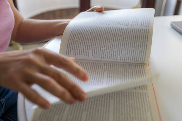 istock Close-up of a woman's hand with a book 2201917694