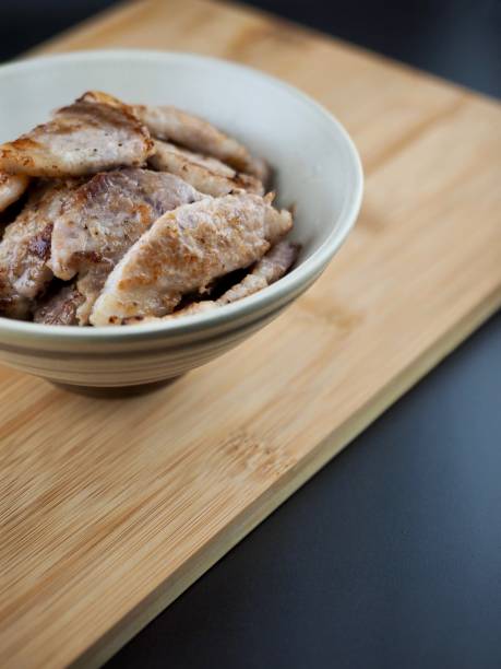 Grilled pork belly in a ceramic bowl