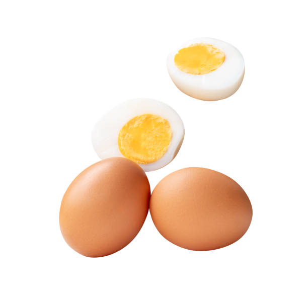 istock Top view set of two raw chicken eggs and cooked or boiled egg with egg yolk in two halves isolated on white background with clipping path 2201922905