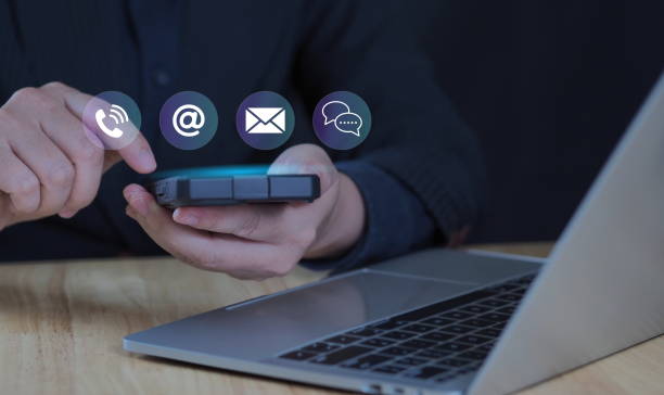 istock Customer support hotline Contact us people connection. Businessman using Smart Phone with the email, call phone, address, Chat message icons 2201925711