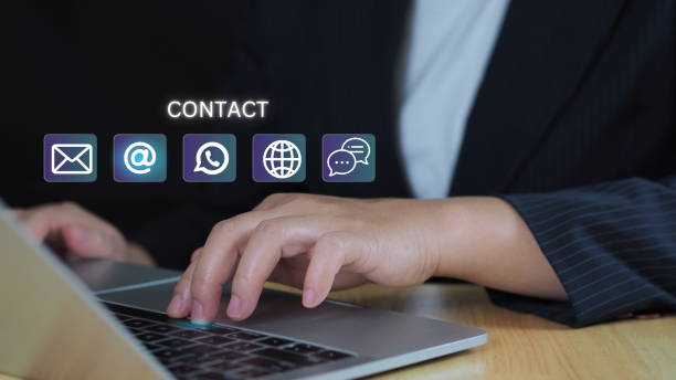 istock Website page contact us or e-mail marketing concept, Customer support hotline Contact us people connection. cube wood with the email, call phone, address, Chat message icons. on keyboard computer. 2201925712