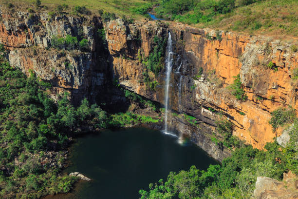 istock Stunning waterfall cascading into a serene pool surrounded by rocky cliffs in South Africa 2201926625
