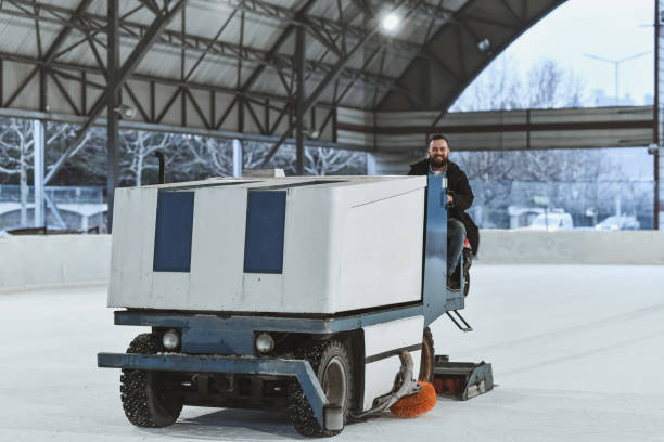 istock Cheerful Worker Operating Ice Resurfacer at Indoor Ice Skating Rink 2201927035