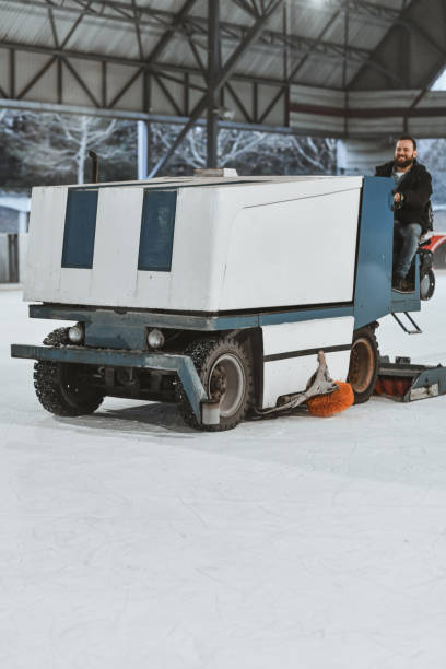 istock Handsome Worker Operating Ice Smoothing Machine Preparing Ice Rink For Skating 2201927048