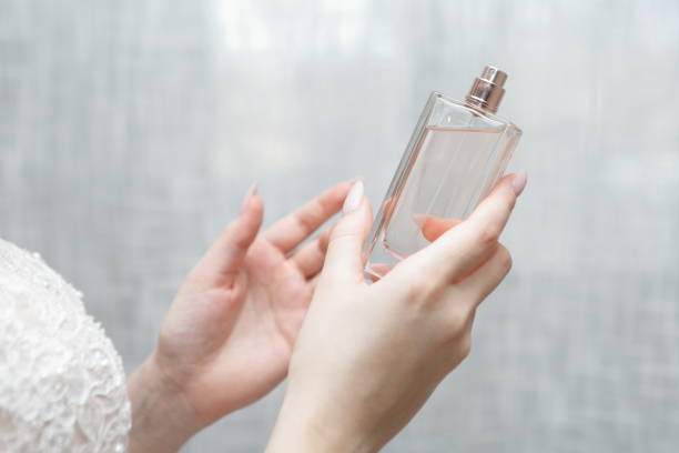 istock Elegant bride holding in hands a bottle of luxury perfume 2201928386