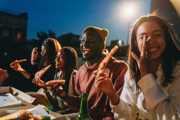 istock Friends are dining together with pizza 2201928502