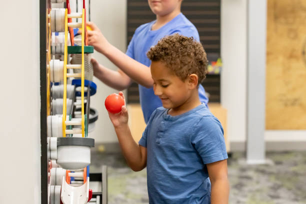 istock Elementary age little boys use STEM toys in play therapy classroom 2201929460