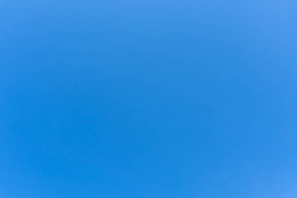 Low angle view and full frame of beautiful light blue sky without clouds in the morning or afternoon on sunny day is used as natural background texture in decorative art work.