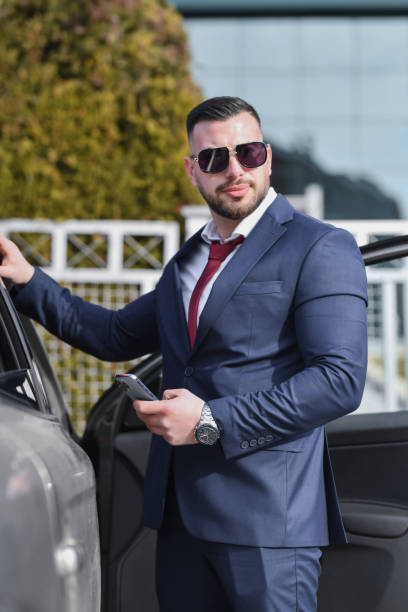 istock Confident Businessman Returning From Business Trip Getting Out of Car 2201932012