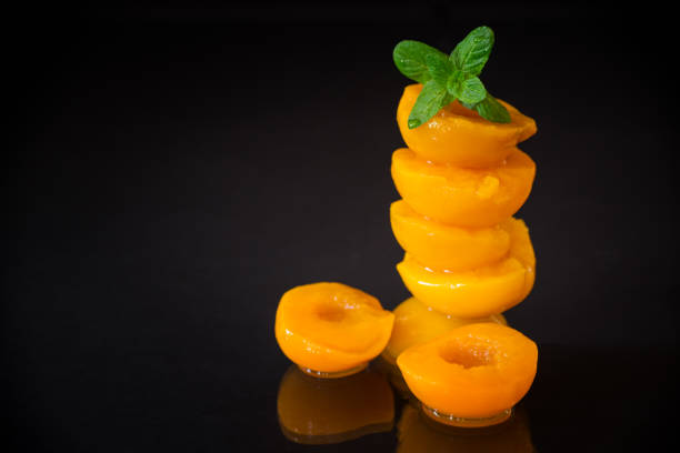 Glossy pickled peaches, macro photography.
