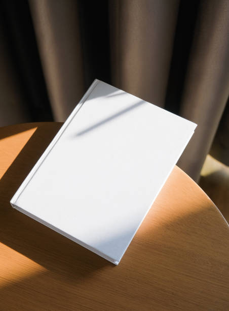 istock blank book mockup on wooden coffee table , shadow overlay 2201933204