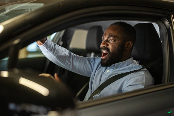 istock Man frustrated while driving in a car on a city day 2201933790