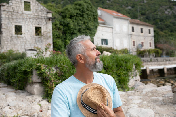 istock Senior Man Embracing the Sun’s Warmth 2201935318