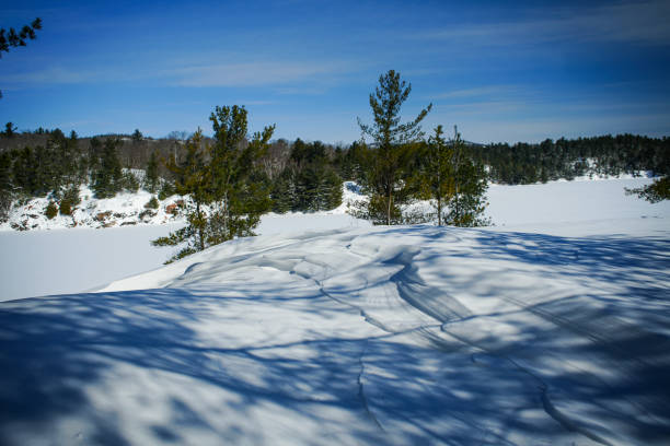The snowy hills surrounding George Lake at Killarney Provincial Park. Untouched by humans formed only by the wind.